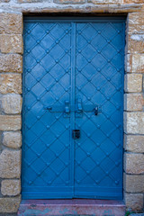 Blue ancient iron castle door with stone lintel