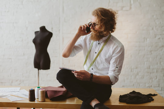 Designer talking phone in parlour