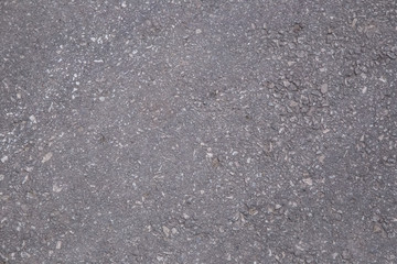 background texture of rough asphalt.A smooth dark grey asphalt pavement texture with small rocks.Asphalt texture