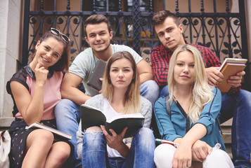 Group of students studying on steps outside