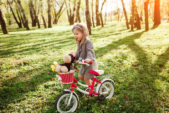 Little girl riding bike in woods