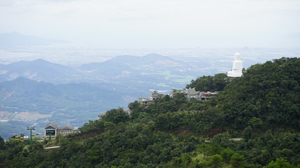 Fototapeta na wymiar Buddha looks at the city from the mountain