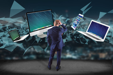 Businessman in front of a wall with Computer and devices displayed on a futuristic interface with interantional network - Multimedia and technology concept