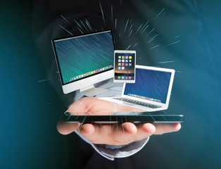 Computer and devices displayed on a futuristic interface with business network - Multimedia and technology concept