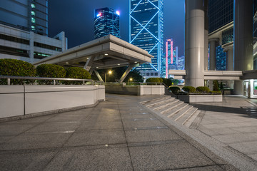 square front of modern office buildings in Hong Kong financial district.