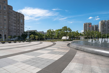 square front of modern office buildings in Shanghai financial district.