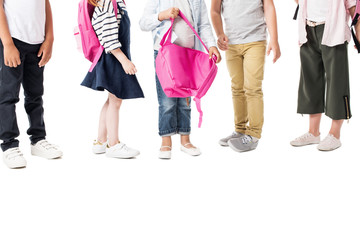 cropped shot of multiethnic children with backpacks standing together isolated on white