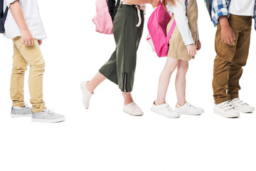 cropped shot of multiethnic children with backpacks standing together isolated on white