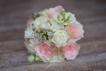 Pastel bridal round bouquet with pink and white roses. Floral arrangement ideas for the bride and bridesmaids