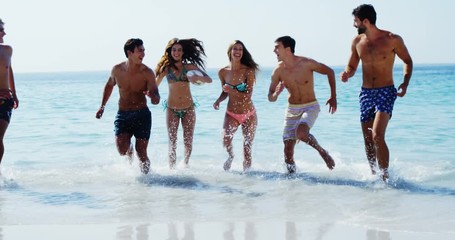 Friends having fun at beach - Powered by Adobe