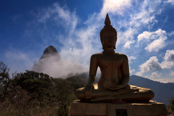 Buddha with the mist in the nature at Doi Nork, Chiang Mai, Thailand