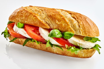 Baguette sandwich with cheese, tomato and basil