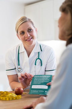 Mature Woman Meeting With Dietitian In Doctors Office