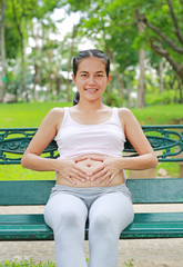 pregnant women sitting in the garden.