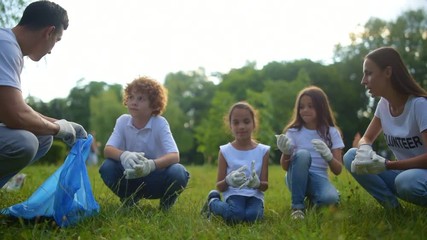 Two volunteers explaining kids nuts and bolts of their work
