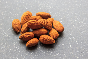almonds in pile on granite background