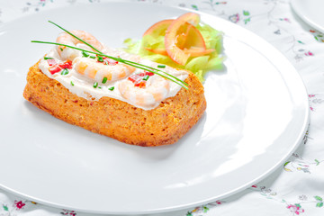 Delicious spanish Fish cake. Hake cake with tuna, tomato, shrimps, chive and salad cream.
