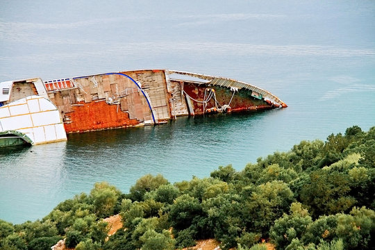 Abandoned and rusty shipwreck near coastline,Greece