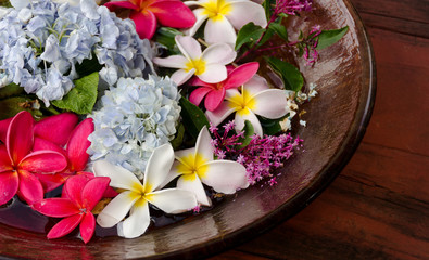 Plumerias on a wooden plate