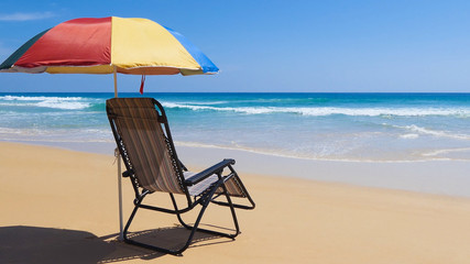 Chair and Umbrella at Karon Beach, Phuket, Thailand on a beautiful day.