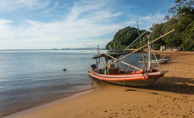 Small fishing boat on a peaceful and beautiful beach, Chanthaburi, Thailand.