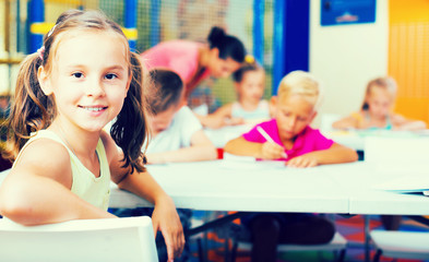 Fototapeta na wymiar Positive schoolgirl in elementary school class