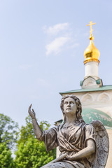 Sculpture of an angel and a church dome on a background