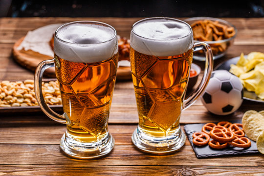 Appetizers and beer on the table for watch the football match.