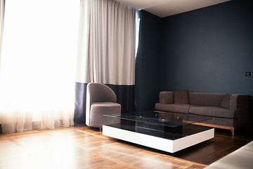 Upholstered furniture and a glass table in the room