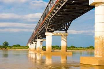 Steel bridge over the Irrawaddy river in Mandalay, Myanmar, Burma. Copy space for text.