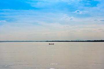 Fishermen in a boat on the river Irrawaddy in Mandalay, Myanmar, Burma. Copy space for text.