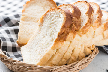 Fresh baked bread and sliced bread on rustic wooden table