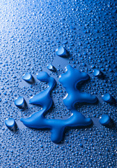 a christmas tree shape between blue water drops
