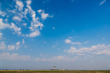  Radar station on background of blue sky / Tower with radar communication system in steppes