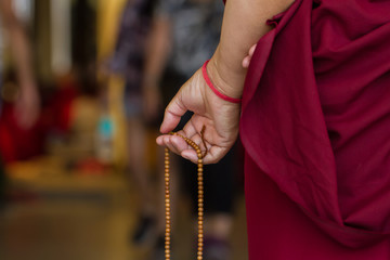 Hands of the monk with the bows
