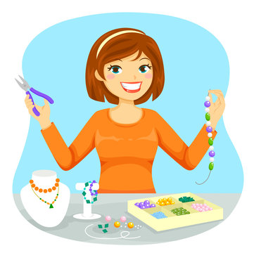 Young woman making jewelry from beads
