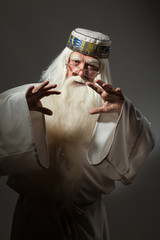 A man in a sorcerer costume on a black background