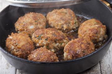 Carrot-meat cutlets with spicy herbs in a frying pan