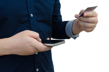 young man holding credit card and using smartphone isolated on white background, online shopping, online payment, lifestyle technology, finances and economy concept, soft focus, selective focus