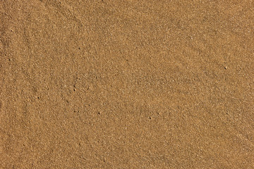Yellow sand on the beach as background with space for the text. Sea travel and holiday concept