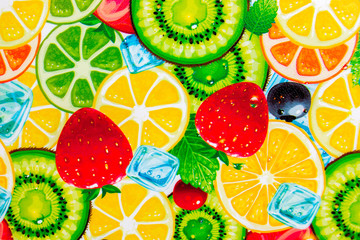 Mixed colorful sliced fruits background