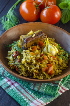 Pilaf on a platter with meat and spices