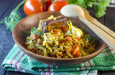 Pilaf on a platter with meat and spices