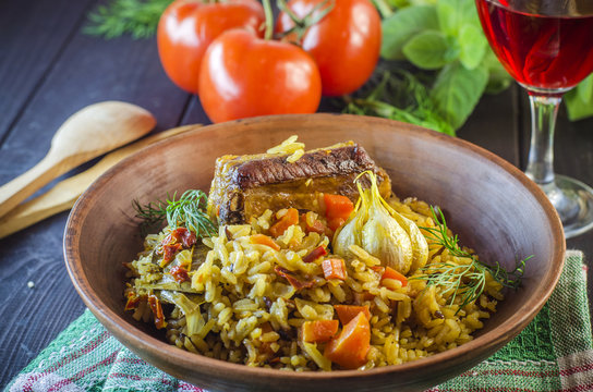 Pilaf on a platter with meat and spices