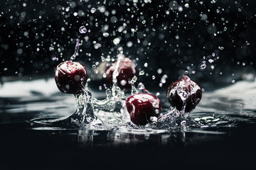 ripe cherries falling in water
