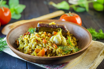 Pilaf on a platter with meat and spices