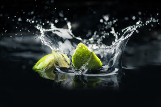 slices of lime falling in water
