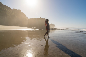 Woman walking on Ocean Shoreline