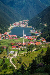 Uzungol(Long Lake):One of the most beautiful tourist places in Turkey.The mountain valley with a trout lake and a small village in Trabzon,Turkey. - obrazy, fototapety, plakaty