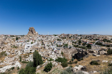 Fototapeta na wymiar View of ancient Nevsehir cave town and a castle of Uchisar dug from a mountains in Cappadocia, Central Anatolia,Turkey. Cappadocia,Kapadokya,Turkish heritage travel. Uchisar pigeon valley.